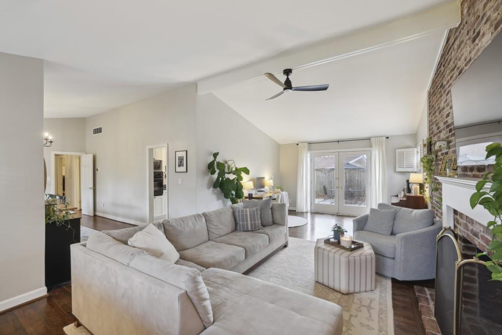 The living area Flows seamlessly through the Living Room's Soaring Ceilings to the Private Backyard.