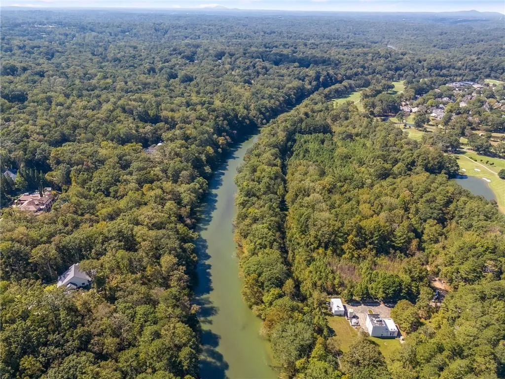Aerial view of property's location with a large body of water