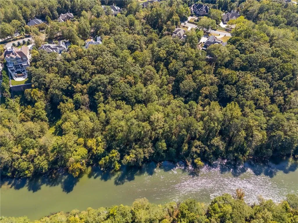 Aerial overview of property's location featuring a heavily wooded area