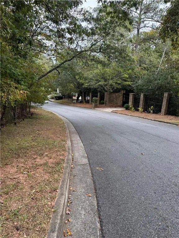 View of asphalt road with curbs