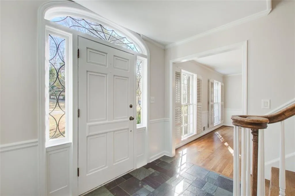 Tile entry in the foyer has tile flooring along with  hardwood flooring on the main level