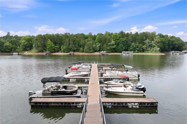 Private multi-slip boat dock featuring wood-finish decking and multiple boat lifts