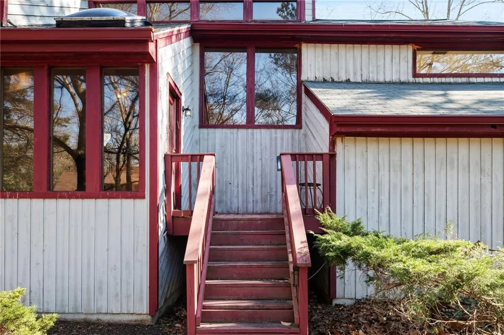 Property entrance with a shingled roof
