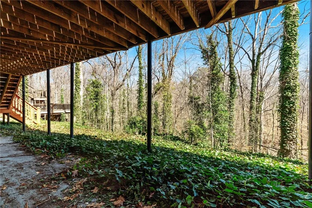 View of yard with a forest view and stairs