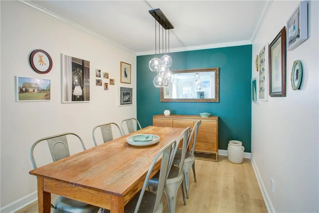 Dining area with ornamental molding and light wood finished floors