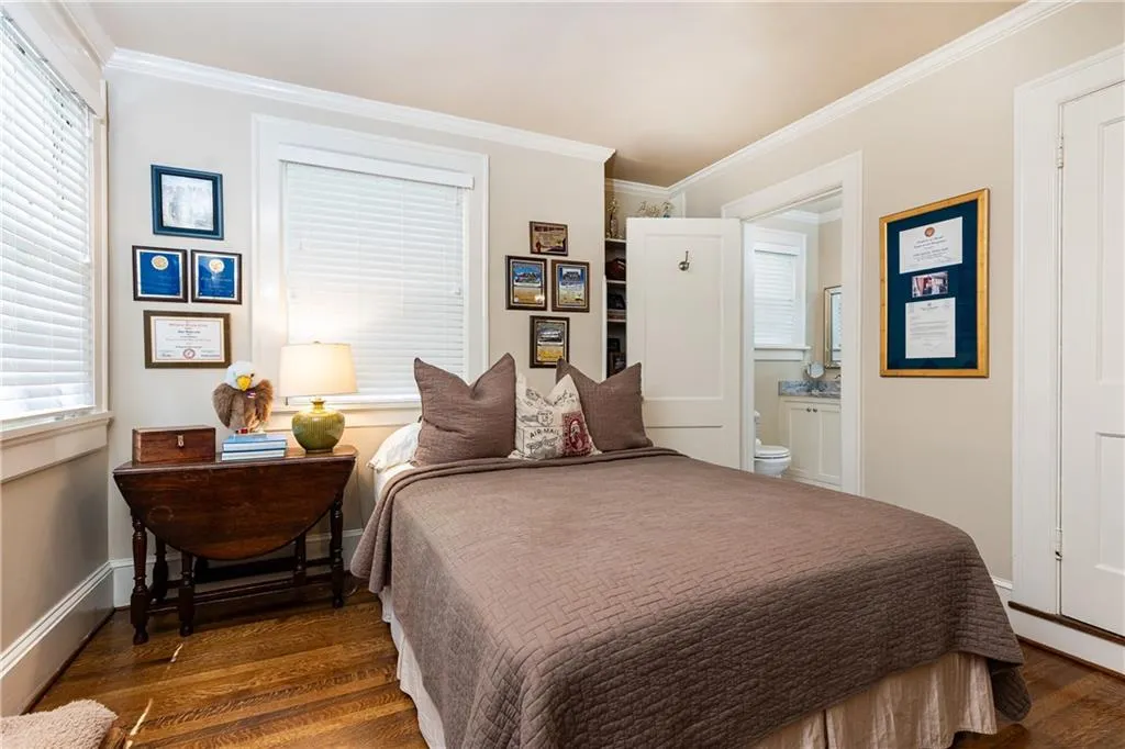 Two bedrooms are adjoined by a full bathroom.