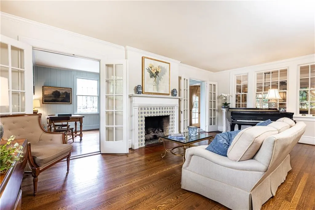 Enjoy the cozy fireplace in the living room, and additional gathering space through the classic french doors.