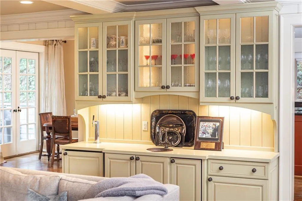 A wet bar with beautiful built in cabinetry in the family room adds an element of charm and class when entertaining guests.