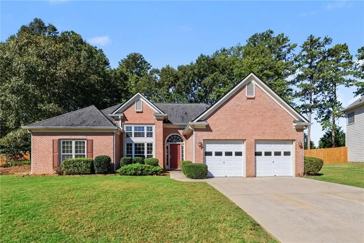 Brick exterior with an arched entryway and two-car garage