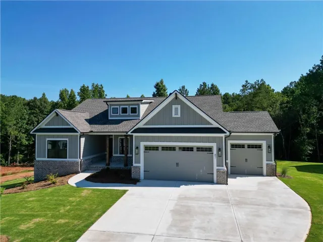 Craftsman-style exterior featuring a combination of horizontal siding and stone accents