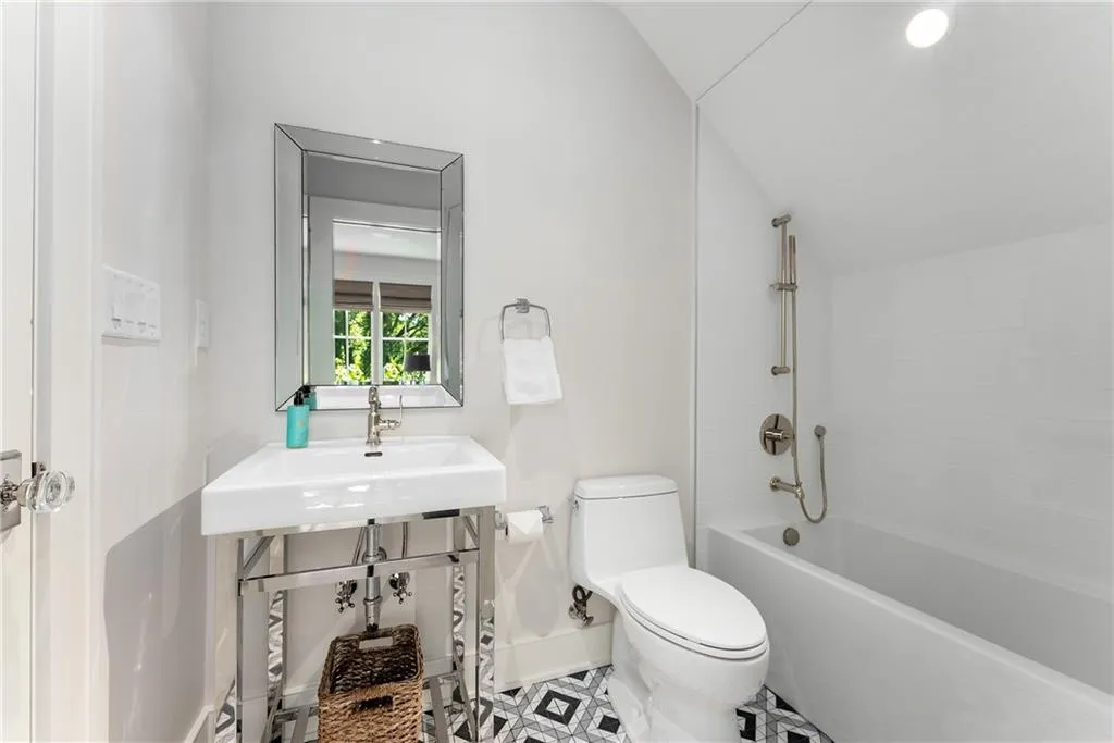 Top Floor Full bath with bathtub / shower combination, lofted ceiling, and tile patterned flooring