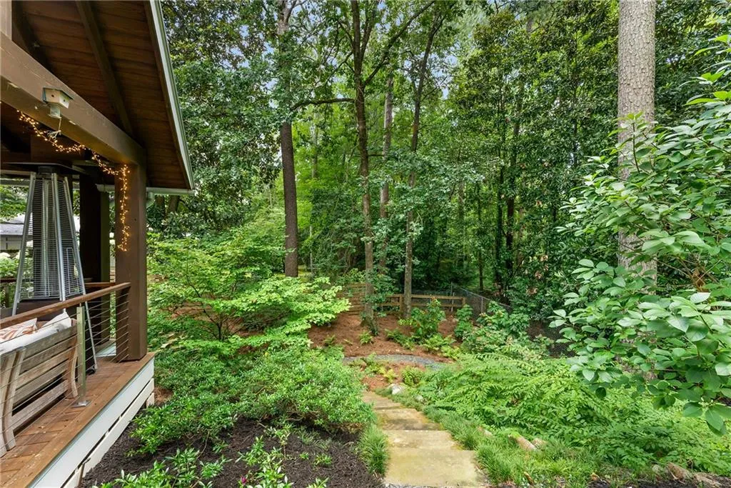 View of yard with path down to basement entrance