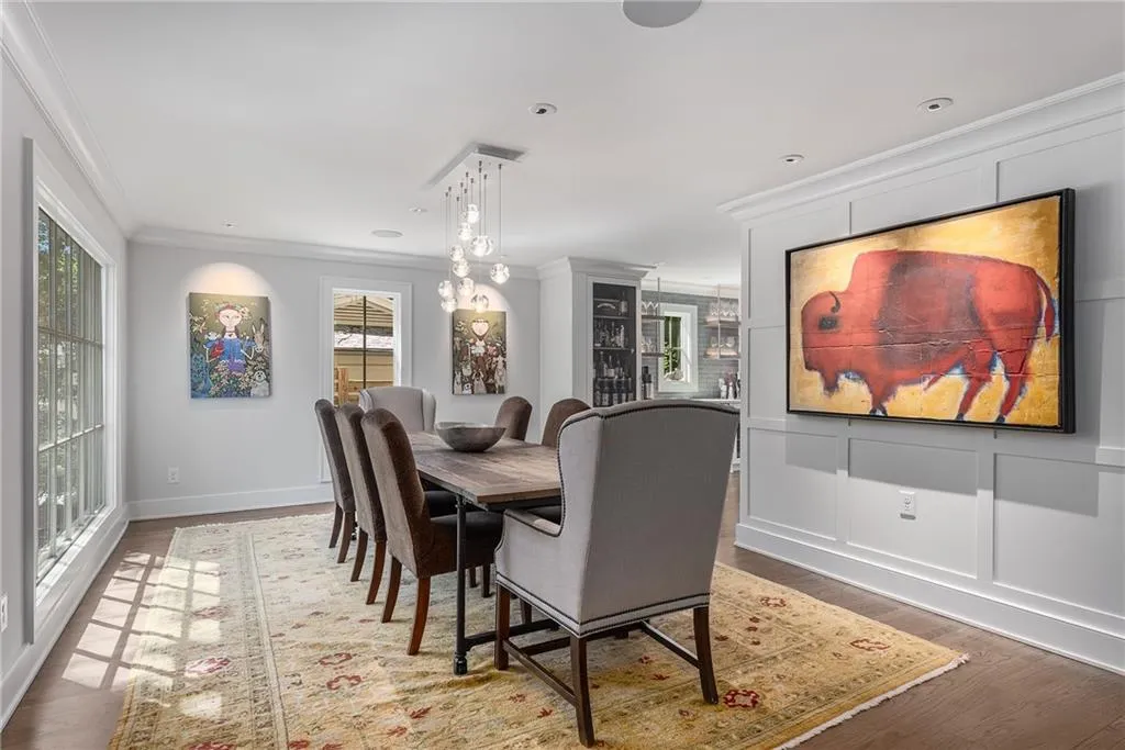 Dining room featuring wood finished floors and ornamental molding