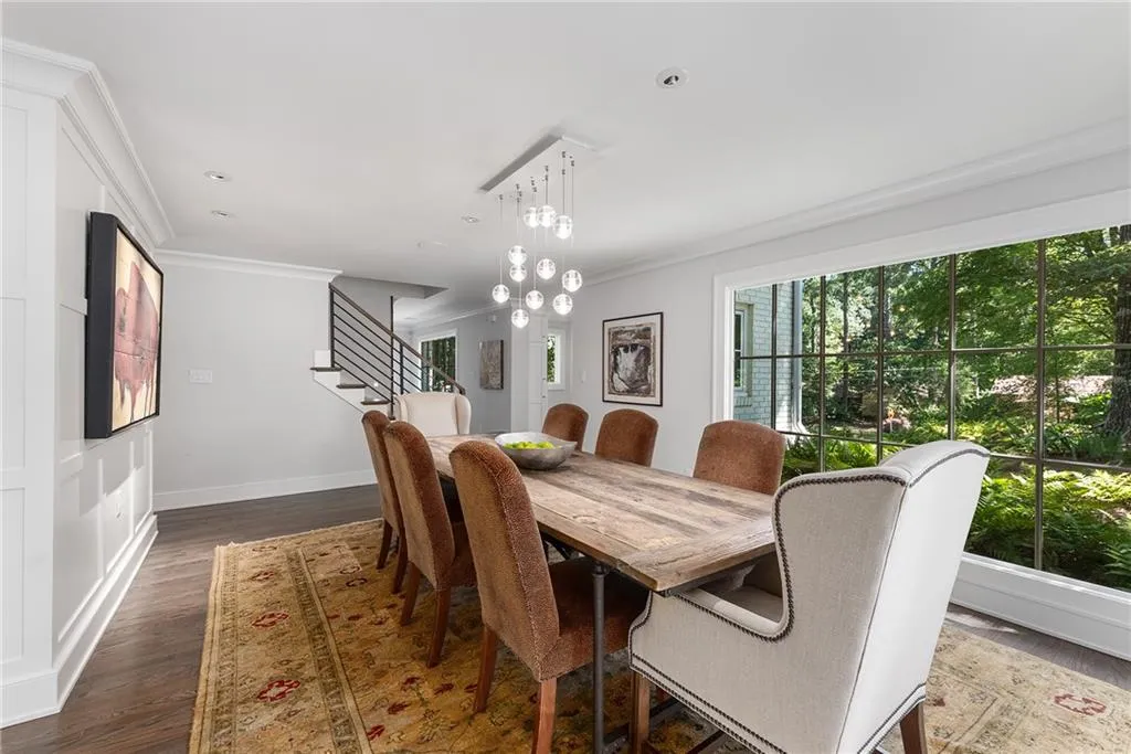 Dining room with crown molding, dark wood-style floors, stairway, a chandelier, and recessed lighting