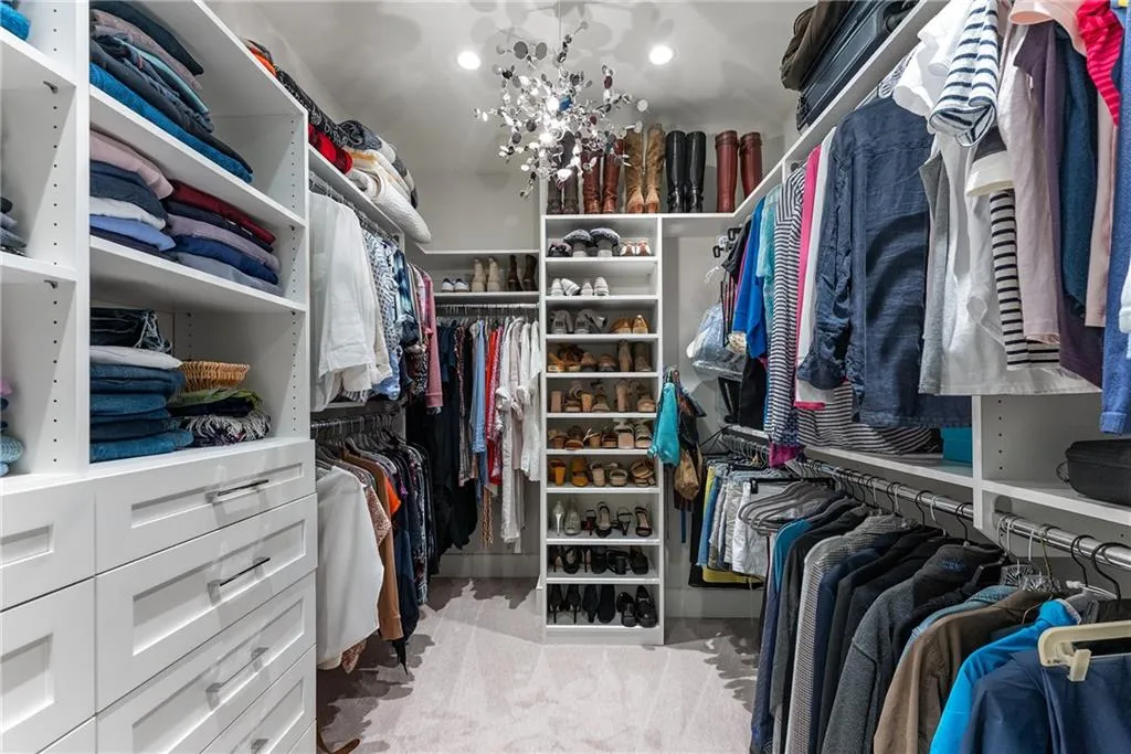 Walk in closet featuring light colored carpet