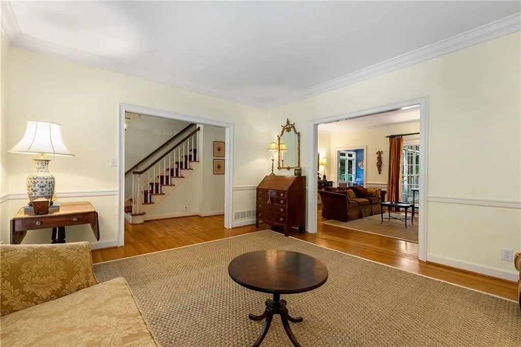 Living room with hardwood finished floors, crown molding, and view towards foyer and Family Room.  Home has a great open and natural flow - perfect for entertaining.