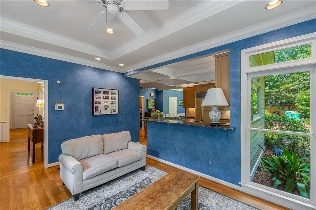 Family/keeping room featuring recessed lighting, crown molding, hardwood floors, ceiling fan, and access to deck.  Tons of light.