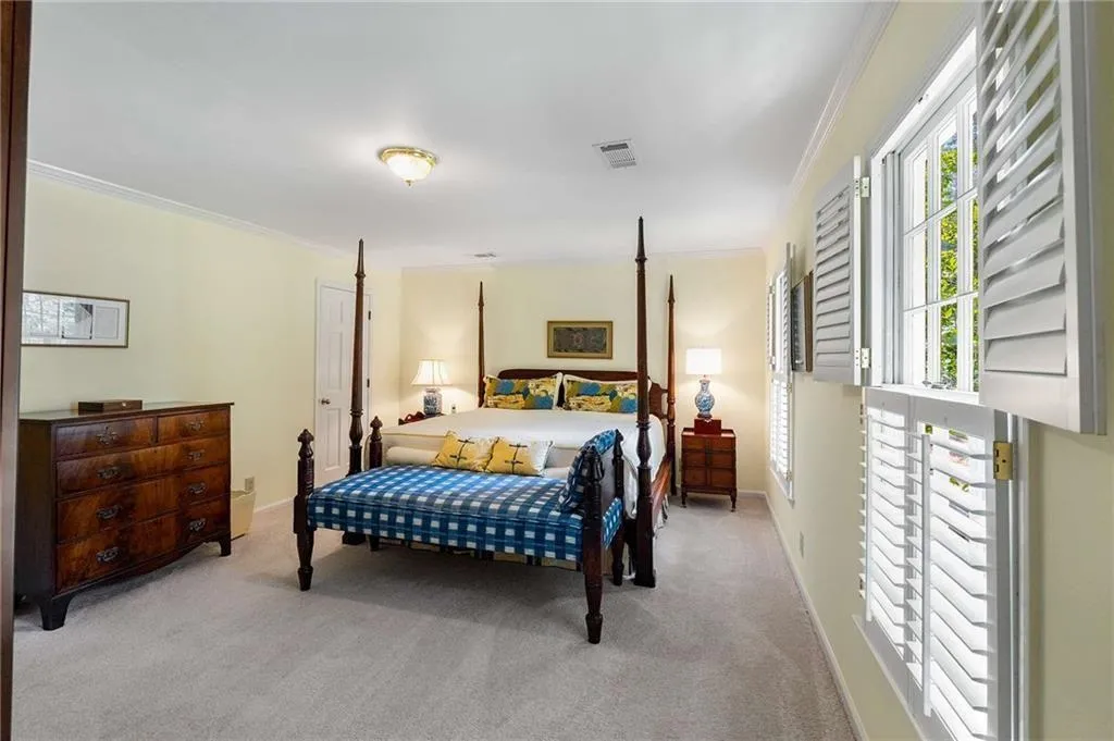 Bedroom featuring crown molding and carpet floors