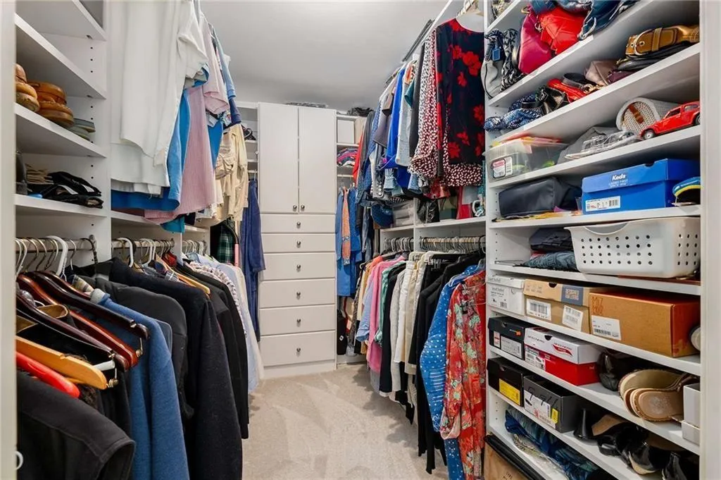 Large Spacious closet in primary with carpet floors
