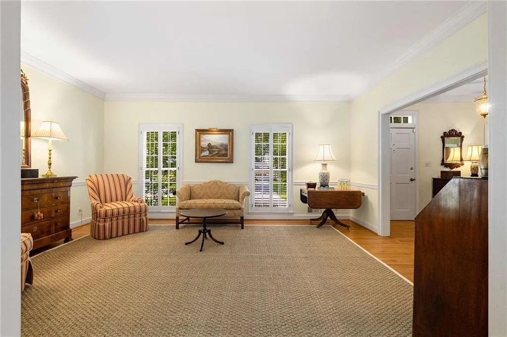 Living room featuring light hardwood flooring and ornamental molding.  Home has a great open and natural flow.