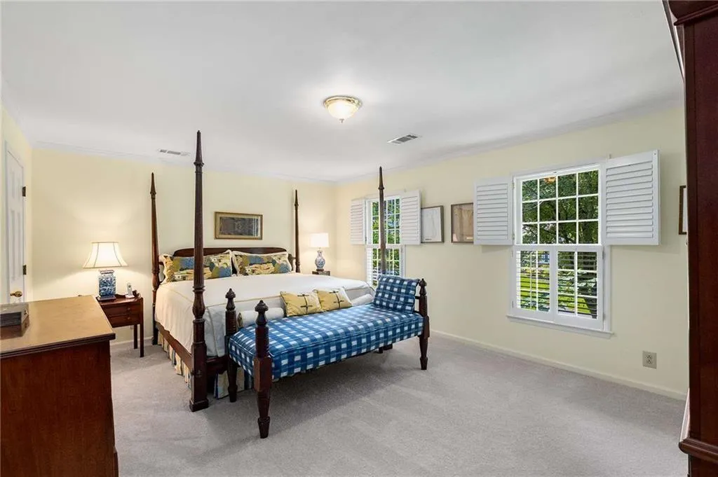 Bedroom with light carpet and crown molding