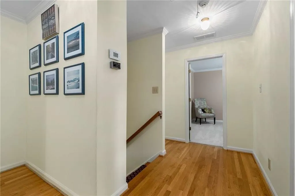 Recently redone (replaced carpet with hardwood) upstairs landing with ornamental molding and hardwood flooring