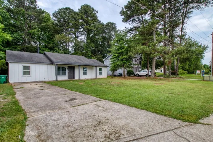 Single-story residence with white siding and gray trim