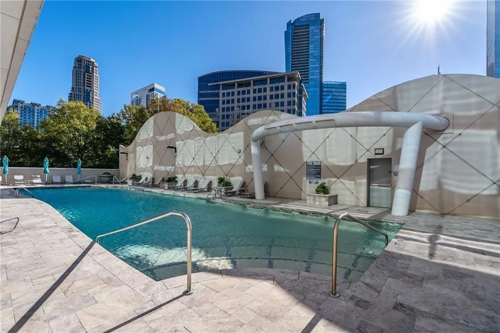 Community pool featuring a city view and a patio