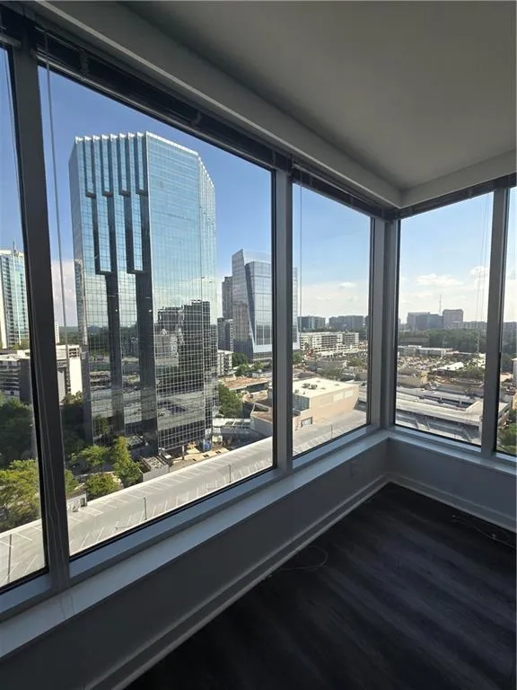 Spare room featuring a view of skyline and wood finished floors