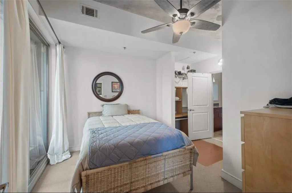 Bedroom featuring light colored carpet and ceiling fan