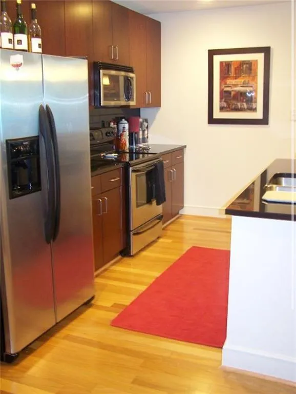 Kitchen featuring sink, stainless steel appliances, and light hardwood / wood-style floors