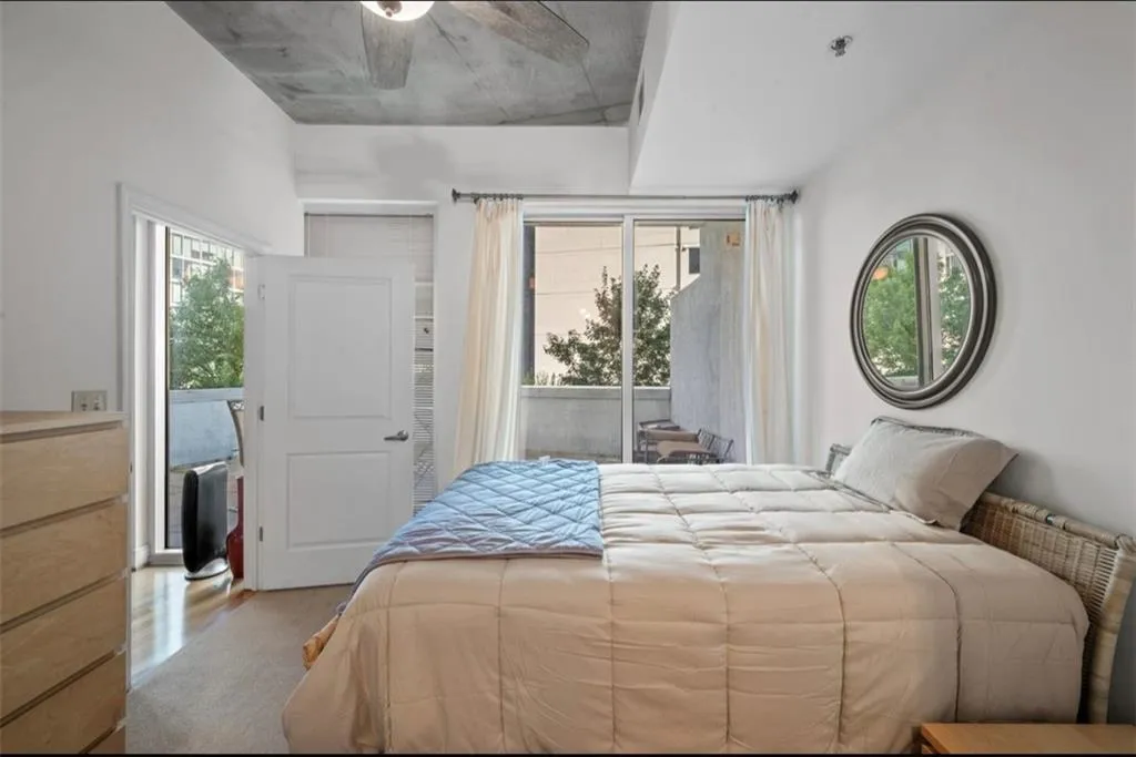 Carpeted bedroom with access to outside and ceiling fan