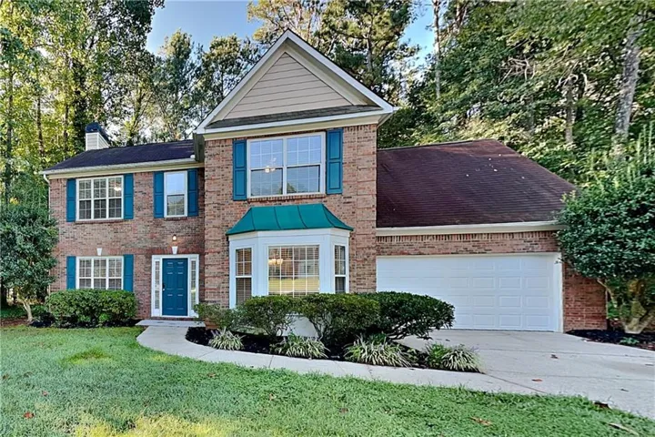 Brick exterior with teal shutters and front door