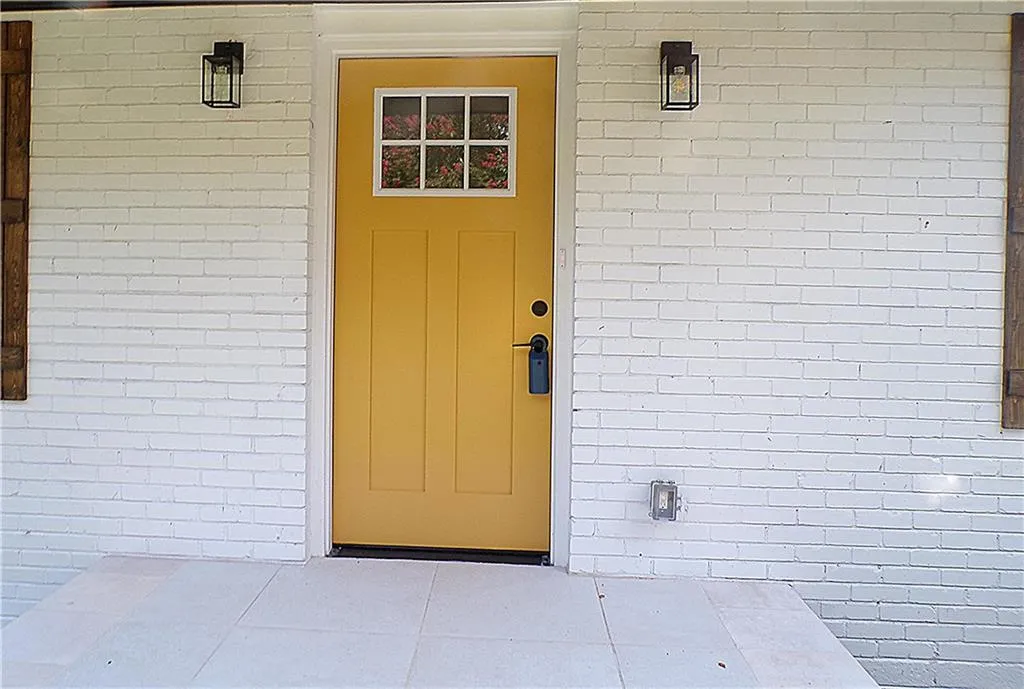 View of exterior entry featuring a patio area