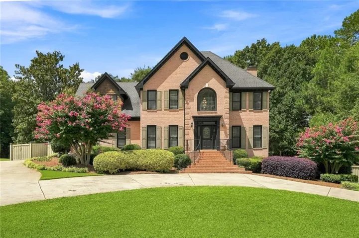 Brick exterior with gabled roof lines and dark shutters