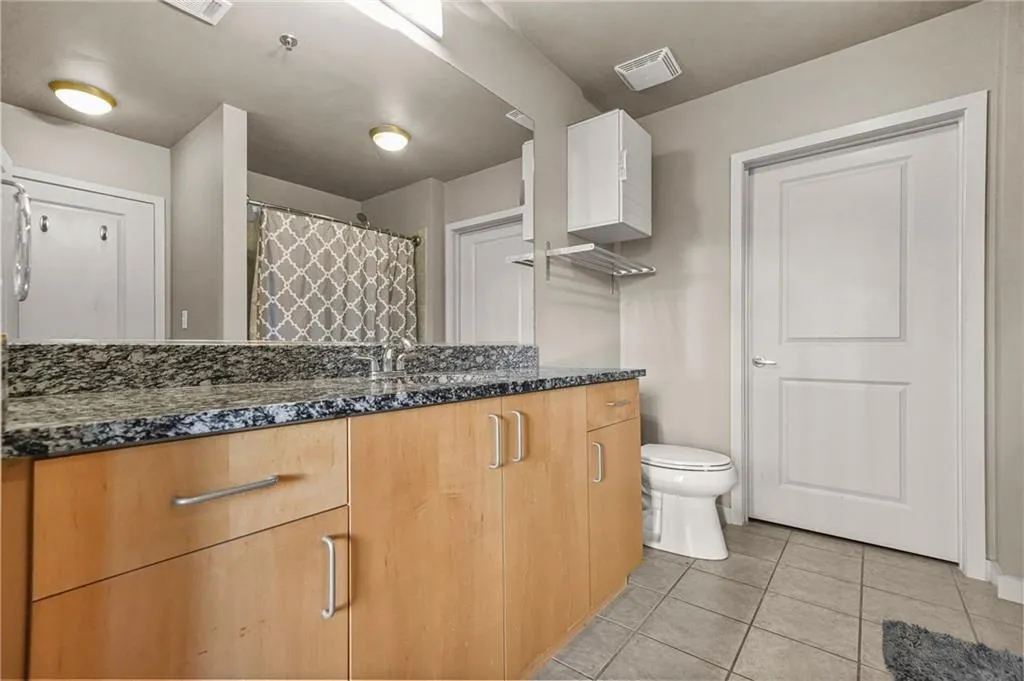 Bathroom with vanity and light tile patterned flooring Bathroom with vanity and light tile patterned flooring