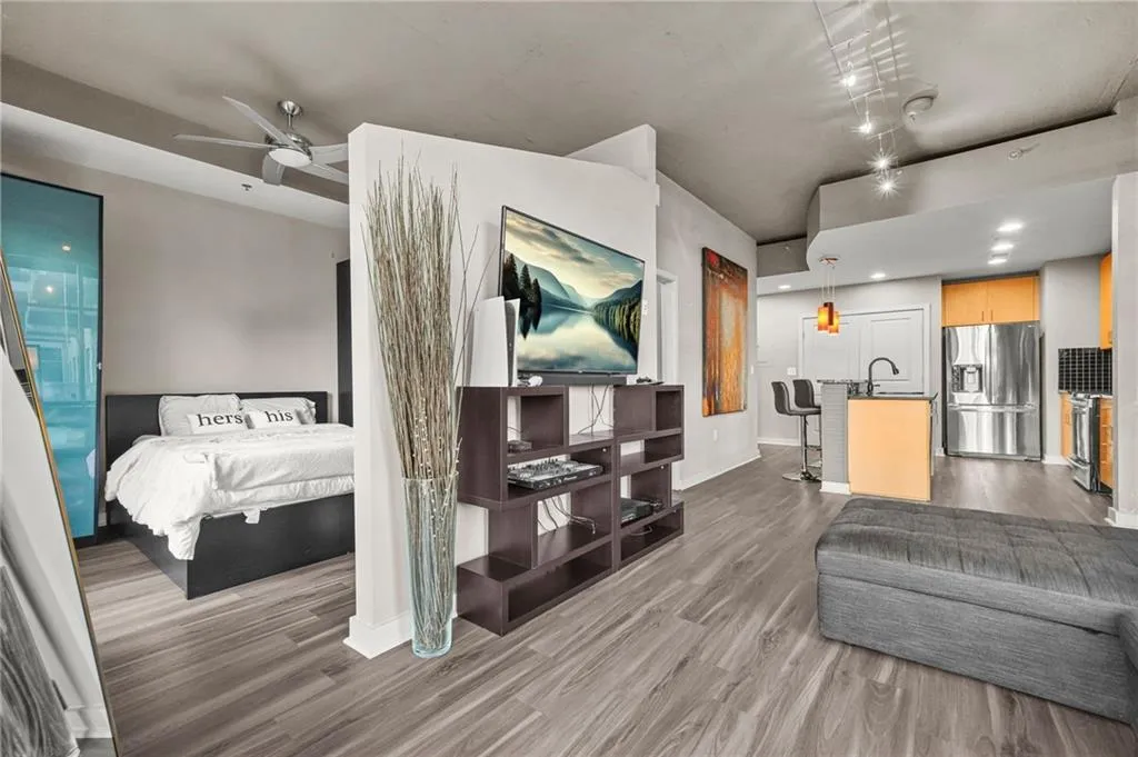 Living area featuring ceiling fan, dark wood-style floors, and recessed lighting Living area featuring ceiling fan, dark wood-style floors, and recessed lighting