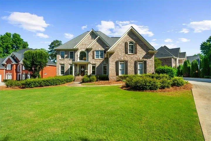 Two-story brick facade residence with multiple gables and dormer windows
