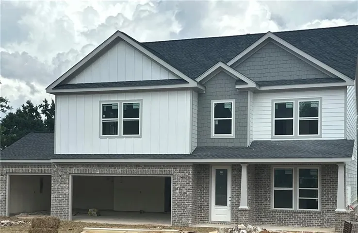 Brick facade with a covered entry, multiple gables, and an attached two-car garage
