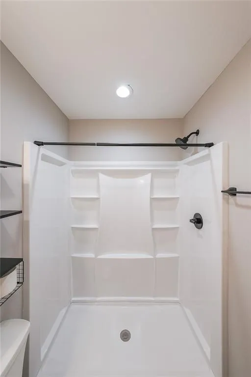 Full bathroom with a shower and toilet