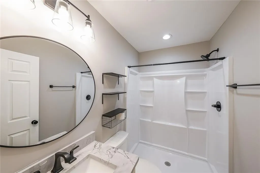 Full bath with a shower and a sink