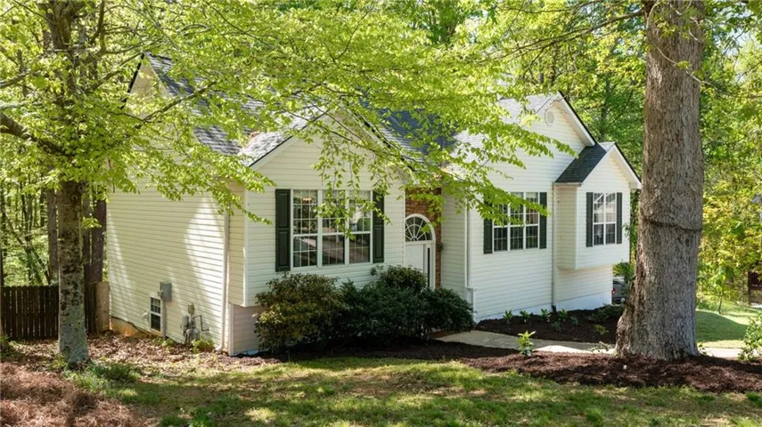 View of front of home with a shingled roof