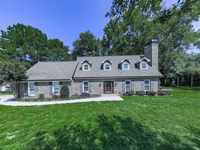 Brick exterior with a gabled roof and dormer windows