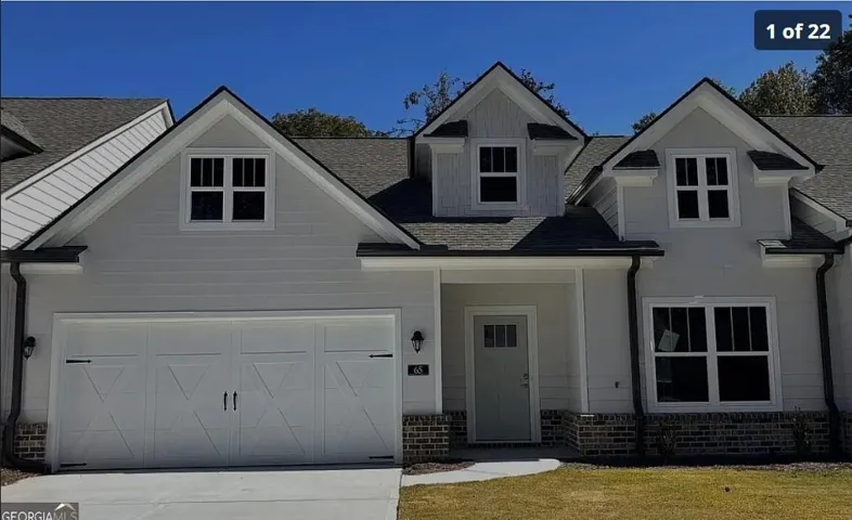 Light-colored siding exterior with dark shingle roofing
