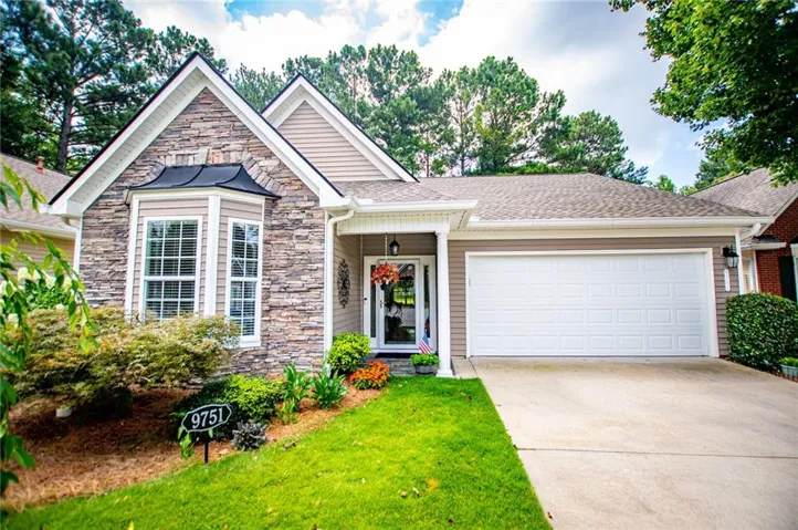 Stone and siding exterior featuring a prominent bay window with white trim