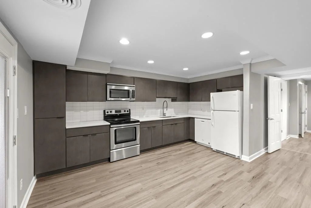 Kitchen featuring backsplash, stainless steel appliances, light hardwood / wood-style floors, and sink