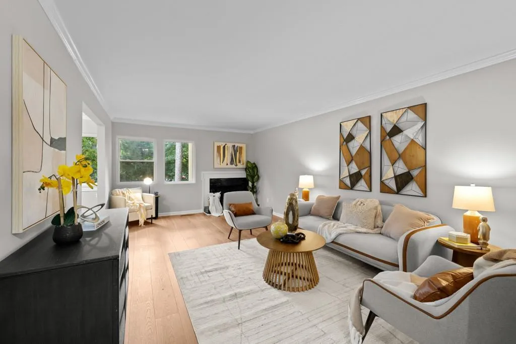 Living room with crown molding and light hardwood / wood-style floors