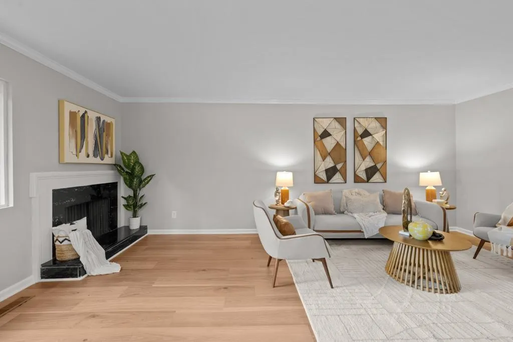 Living room featuring crown molding, light hardwood / wood-style flooring, and a high end fireplace