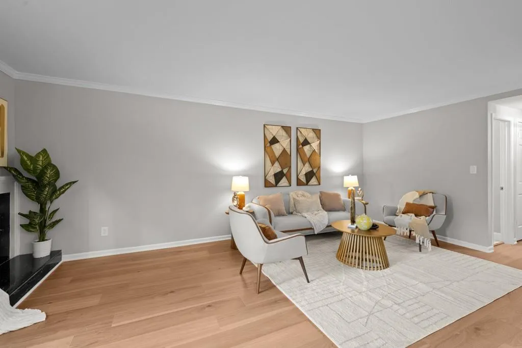 Living room featuring crown molding and light hardwood / wood-style floors