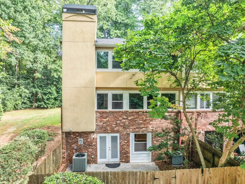 Rear view of property with central AC and french doors
